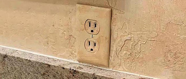 After Faux Camouflage Wall Outlet